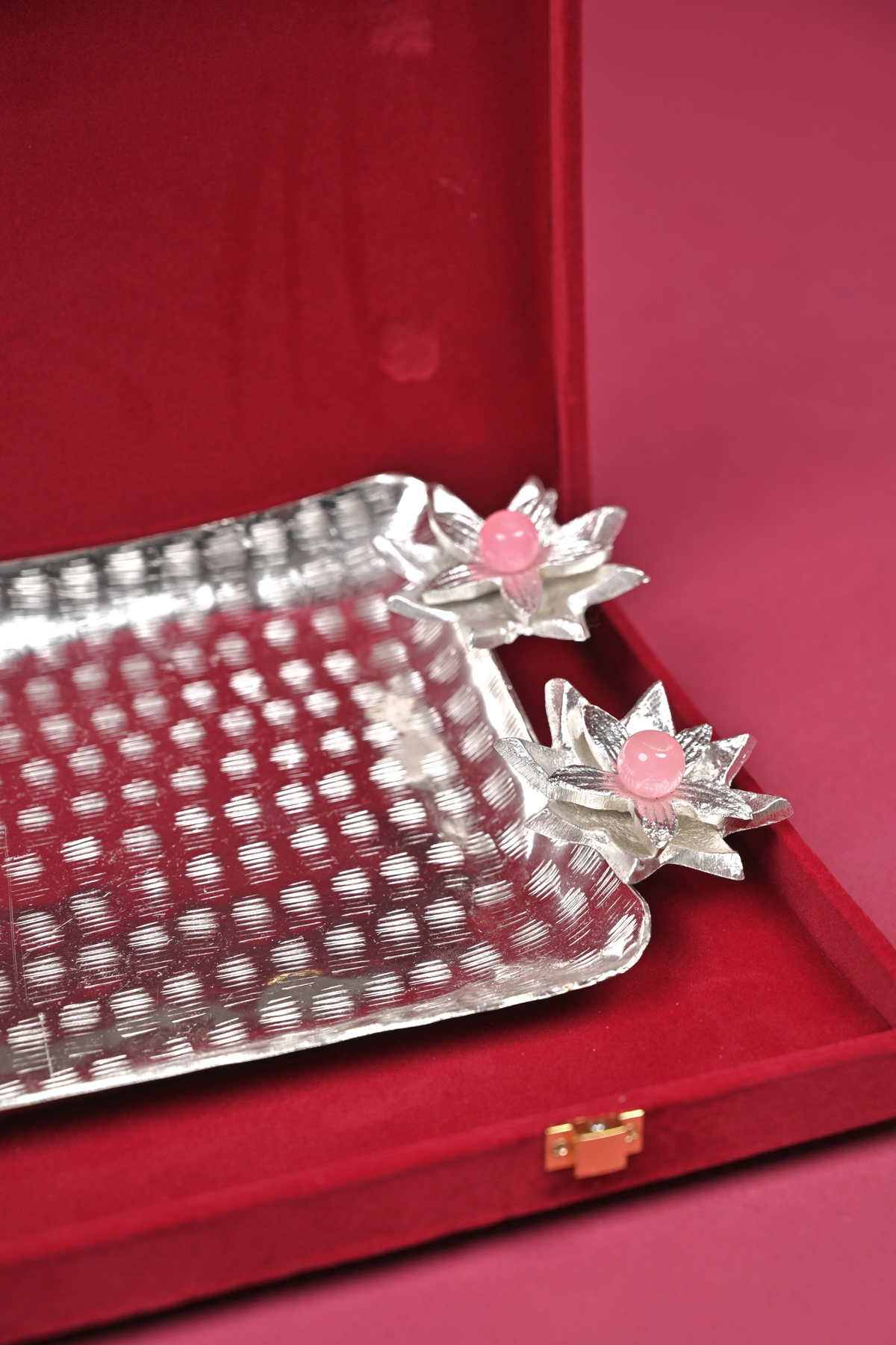 silver floral serving tray with lotus diyas