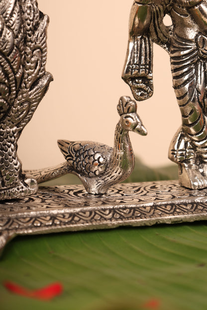 Radha Krishna with Bells and Peacock Frame – Handcrafted German Silver Wall Decor for Temple & Home