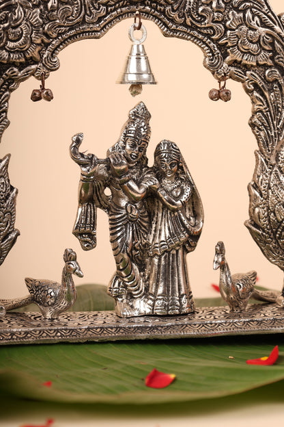 Radha Krishna with Bells and Peacock Frame – Handcrafted German Silver Wall Decor for Temple & Home